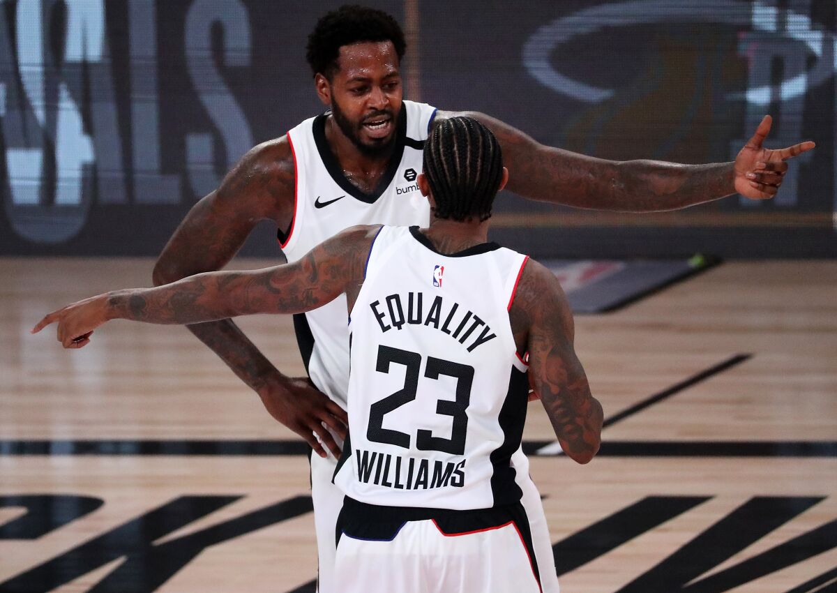 Clippers teammates JaMychal Green and Lou Williams talk strategy during a game last season.