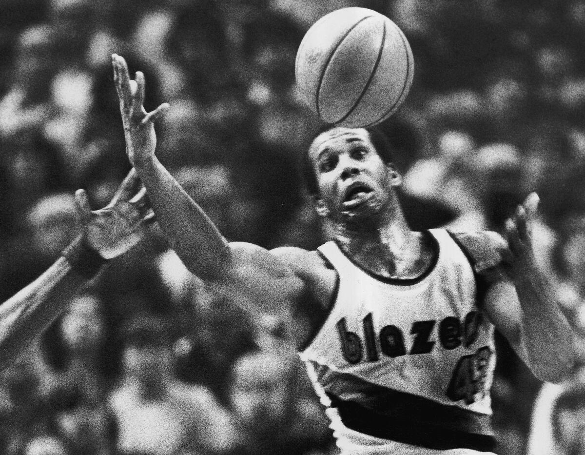 Kermit Washington, pictured as a member of the Trail Blazers, grabs a loose ball during a game against the Warriors on Dec. 25, 1979.