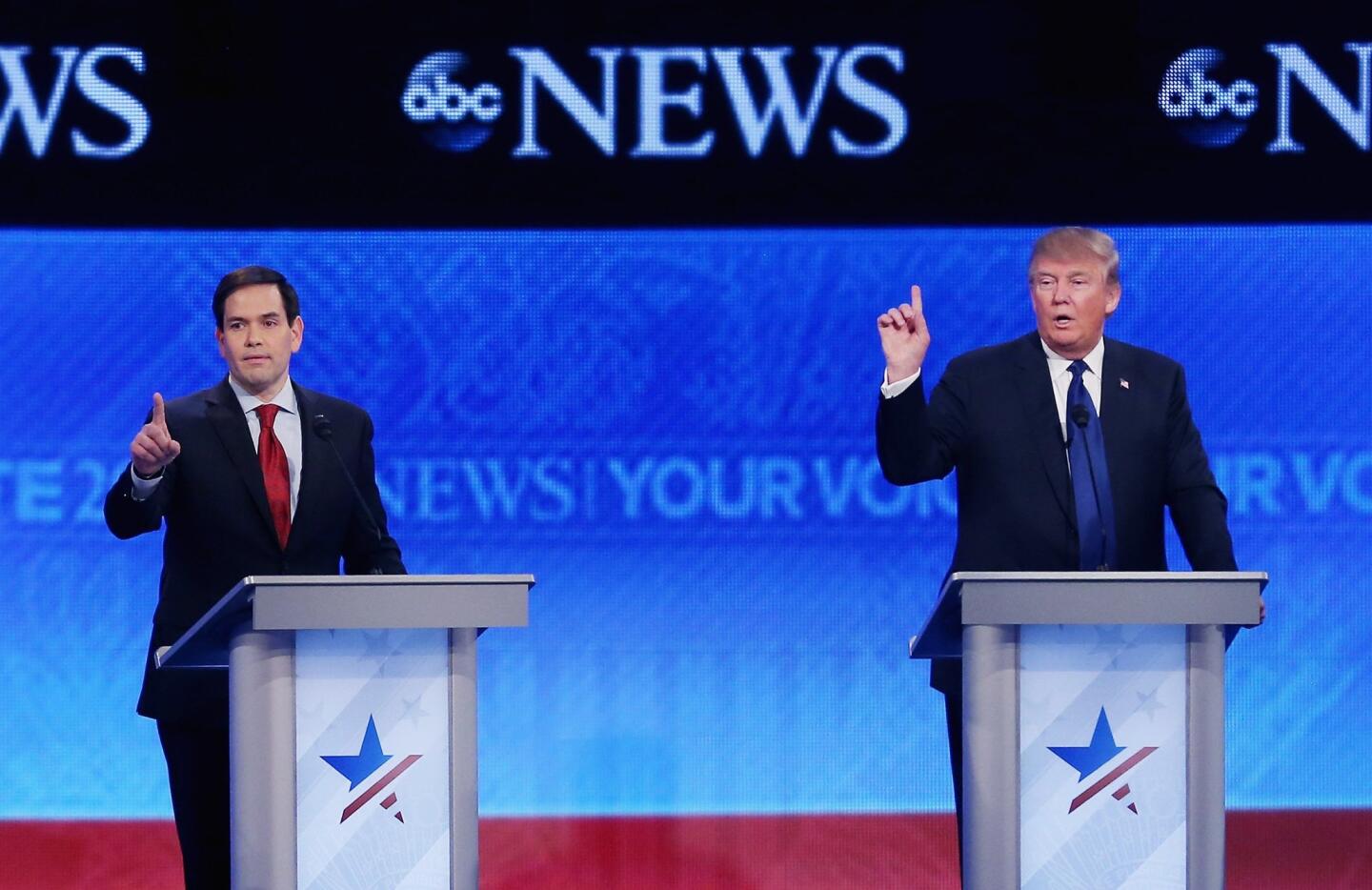 Sen. Marco Rubio of Florida, left, and Donald Trump try to get a word in at St. Anselm College in Manchester, N.H.