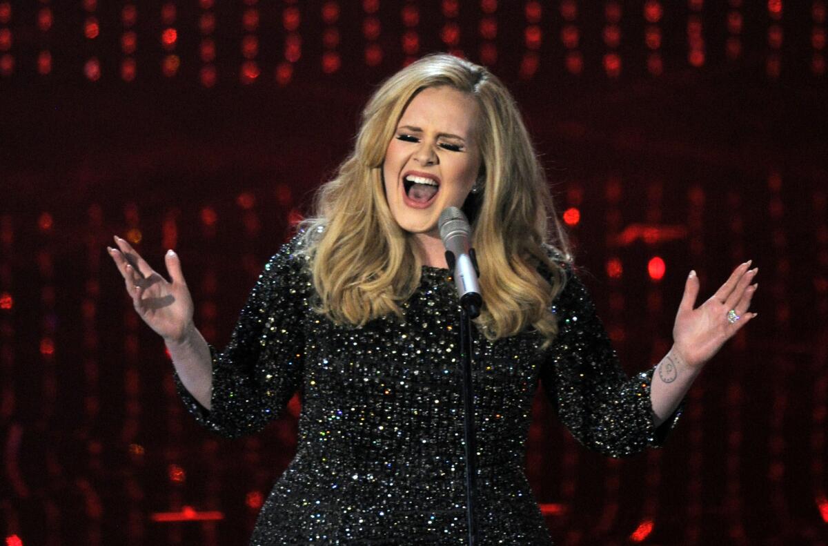 In this Feb. 24, 2013, file photo, Adele performs during the Oscars at the Dolby Theatre in Los Angeles.
