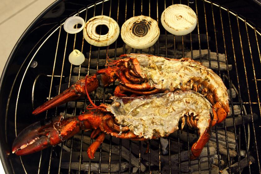 Digital Image taken on Thursday, 6/10/2004, Studio City, CA - Photo by Ricardo DeAratanha/Los Angeles Times -- Lobsters and sweet onion rings, that Chef Ludovic Lefebvre (cq) was cooking on the BBQ using Japanese wood.