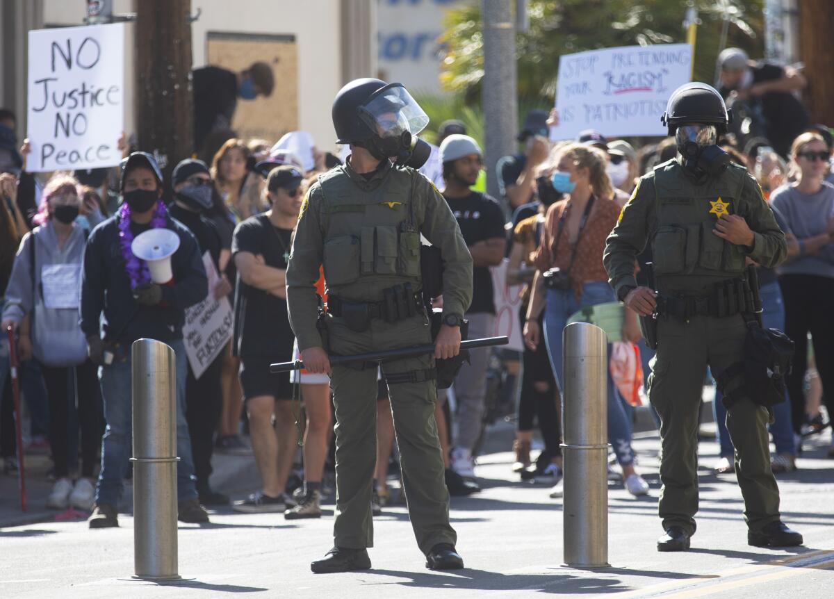 Hundreds of protesters gathered in Huntington Beach on Sunday afternoon to protest the death of George Floyd.