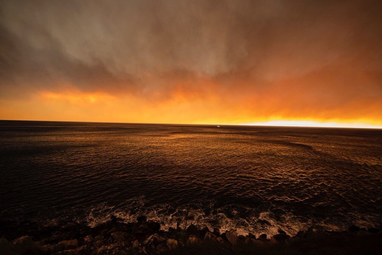 Smoke from the Woolsey fire darkens the sky over the Pacific Ocean near Malibu on Friday.