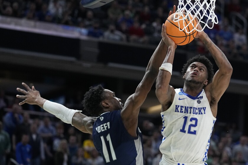 Kentucky forward Keion Brooks Jr. (12) shoots over Saint Peter's forward KC Ndefo (11) during overtime in a college basketball game in the first round of the NCAA tournament, Thursday, March 17, 2022, in Indianapolis. (AP Photo/Darron Cummings)