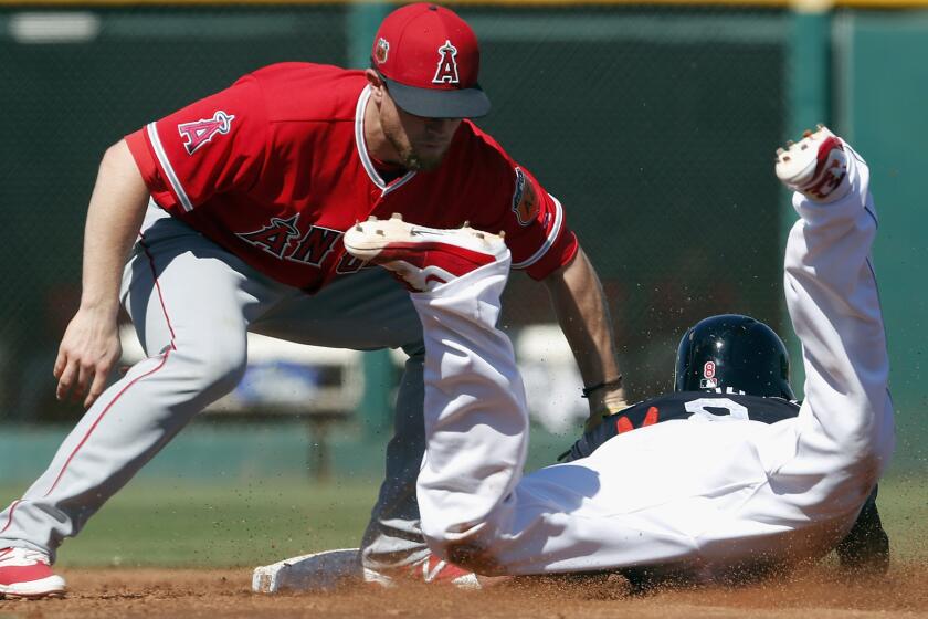 Angels shortstop Nolan Fontana tags out Indians center fielder Lonnie Chisenhall on a steal attempt during the third inning Thursday.