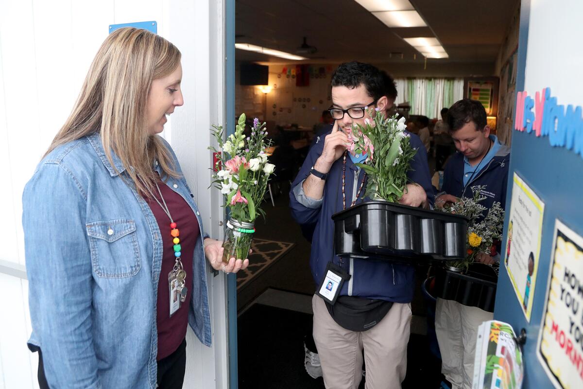 Teacher Kristin Viramontes, with STEP students, Reid Duarte, center, and Connor Carone during a flower delivery Wednesday.