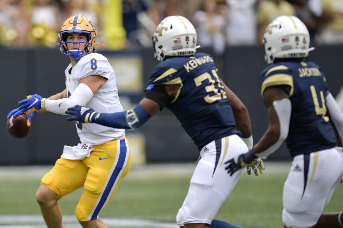 Pittsburgh quarterback Kenny Pickett (8) works against Georgia Tech during the first half of an NCAA college football game, Saturday, Oct. 2, 2021, in Atlanta. (AP Photo/Mike Stewart)