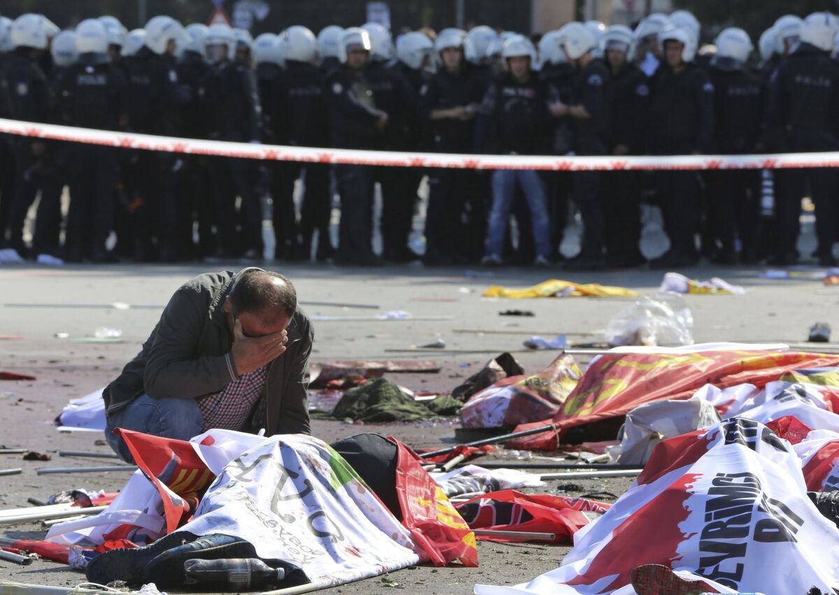 A man cries over the body of a victim at the site of an explosion targeting a peace rally in Ankara, Turkey. (Burhan Ozbilici / Associated Press)