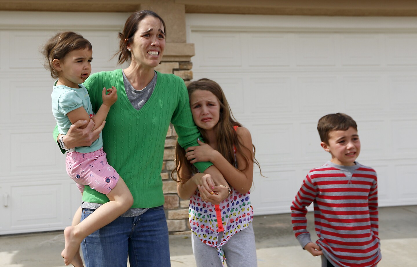 A distraught Summer Page and her children watch as social workers take her 6-year-old foster daughter away.