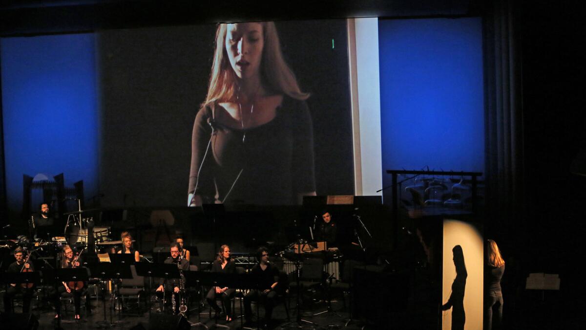 Mezzo-soprano Julia Aks sings during "Translation," one of the works in progress performed during "First Take" at the Wallis Annenberg Center for the Performing Arts. [For the Record: An earlier version of this caption identified the singer on the screen as soprano Maria Elena Altany.]