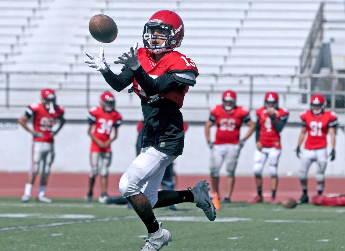 Glendale High School receiver Chris Juarez pulls one down during practice at the Nitros stadium, in Glendale on Friday, Aug. 9, 2019.