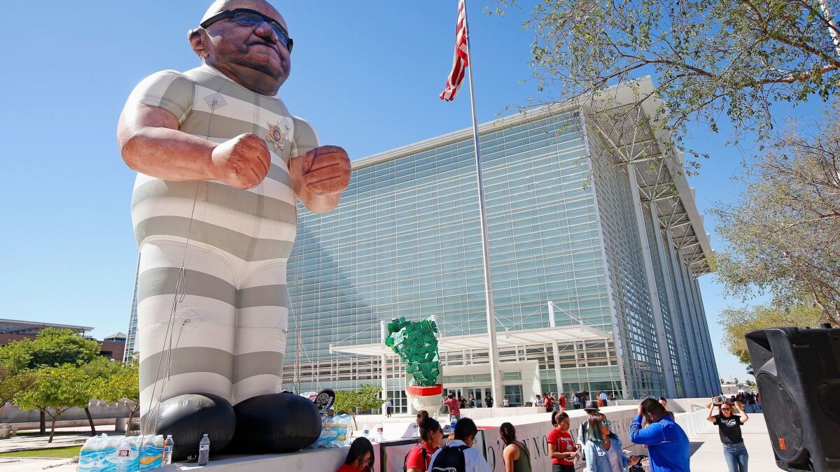 Protesters display an effigy of Maricopa Country Sheriff Joe Arpaio wearing prison clothes in front of U.S. District Court.