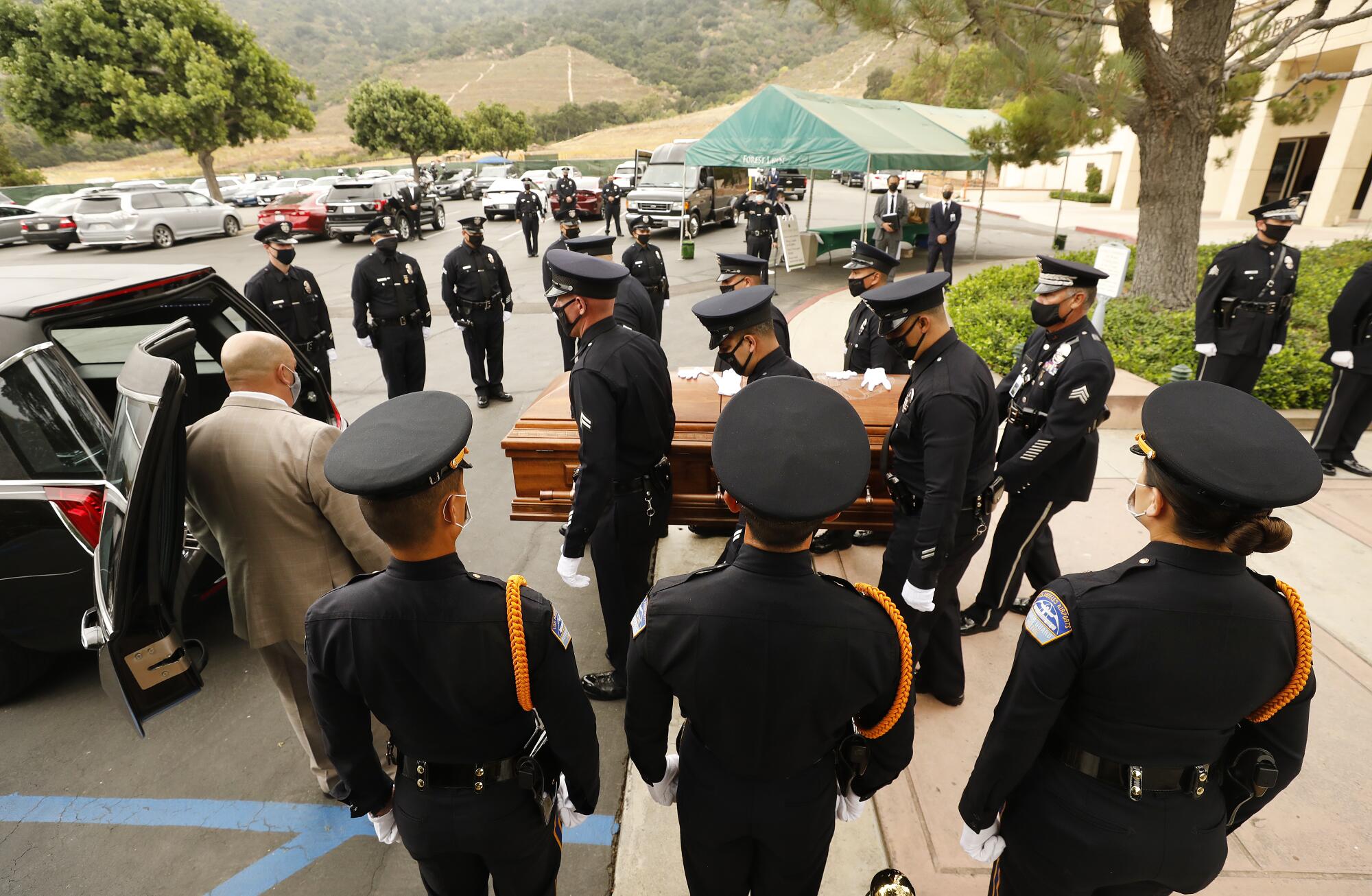 Officer Martinez's coffin is carried after the service. 