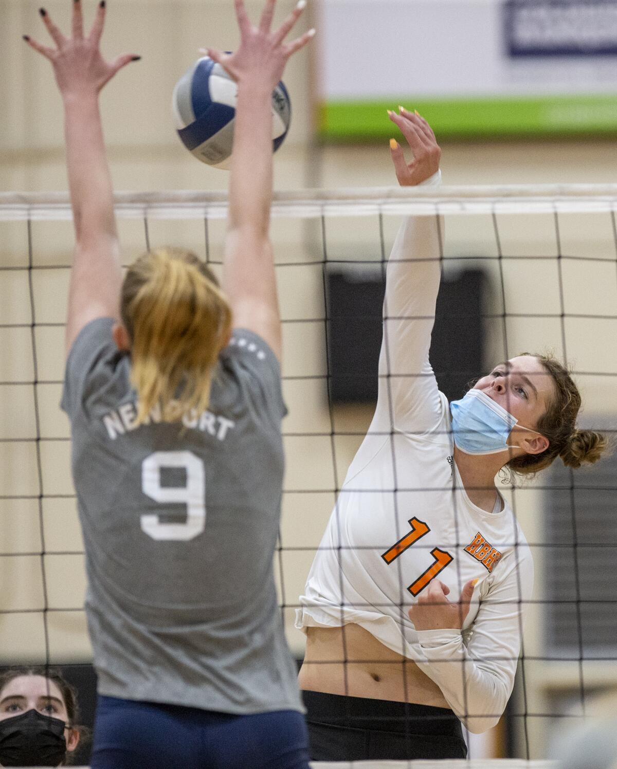 Huntington Beach's Haylee LaFontaine hits against Newport Harbor's Emma Coatsworth.