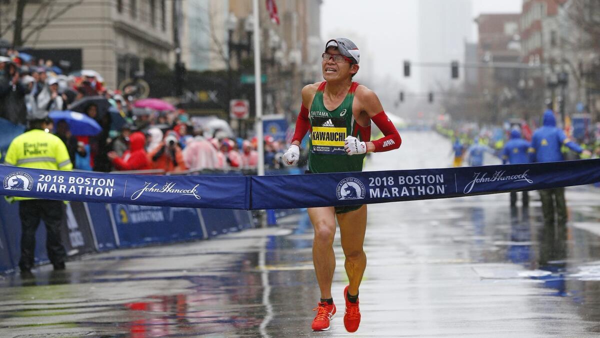 Japan's Yuki Kawauchi of Japan crosses the finish line to win the men's division of the 122nd Boston Marathon.