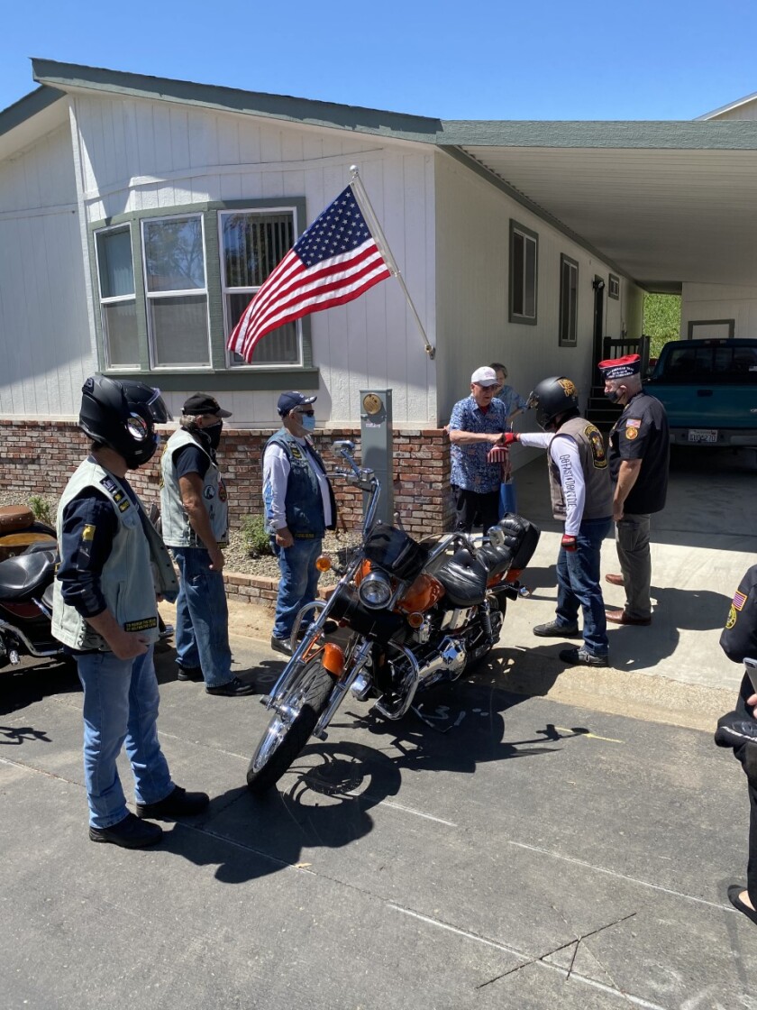 A convoy of motorcycle riders from Escondido's VFW Post 1513 delivers a care package to veteran Ivan Pile.