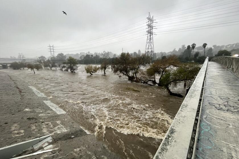 LOS ANGELES, CA - JANUARY 09: The Los Angeles River flows with water from the most recent winter storm as seen from the Sunnynook Pedestrian Bridge in Atwater Village on Monday, Jan. 9, 2023. (Myung J. Chun / Los Angeles Times)