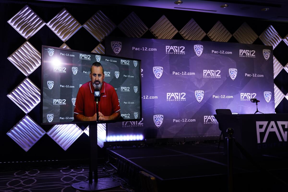 Nick Rolovich appears on a screen at a Pac-12 media event.