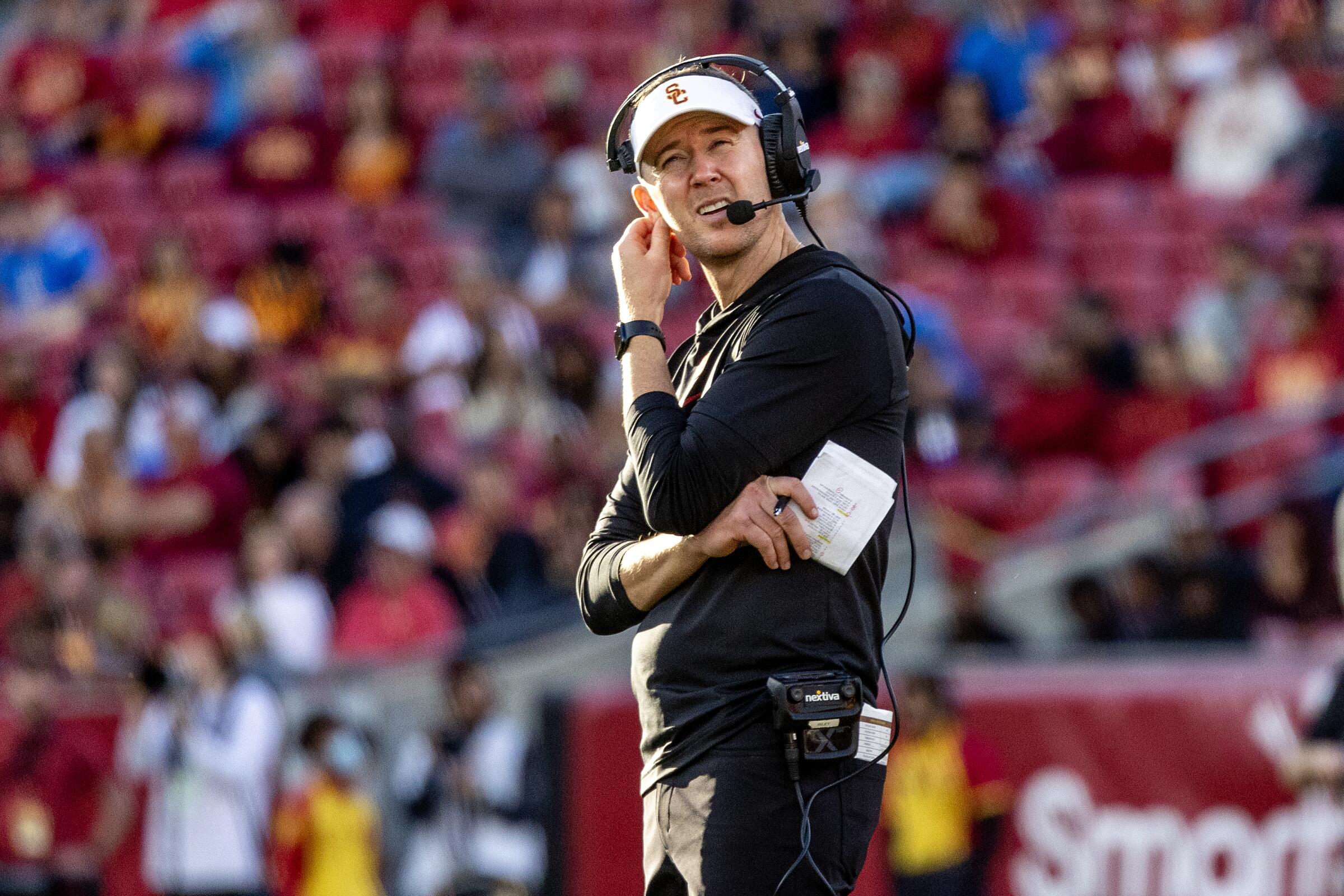 USC coach Lincoln Riley looks at the video board during a replay at the Coliseum.
