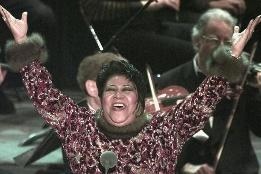 Aretha Franklin raises her arms in jubilation after standing in for Luciano Pavarotti at the last minute at the 40th Annual Grammy Awards Wednesday, Feb. 25, 1998, at Radio City Music Hall in New York. Franklin sang "Nessun Dorma" from Puccini's "Turandot" when Pavarotti called in sick. (AP Photo/Mark Lennihan)