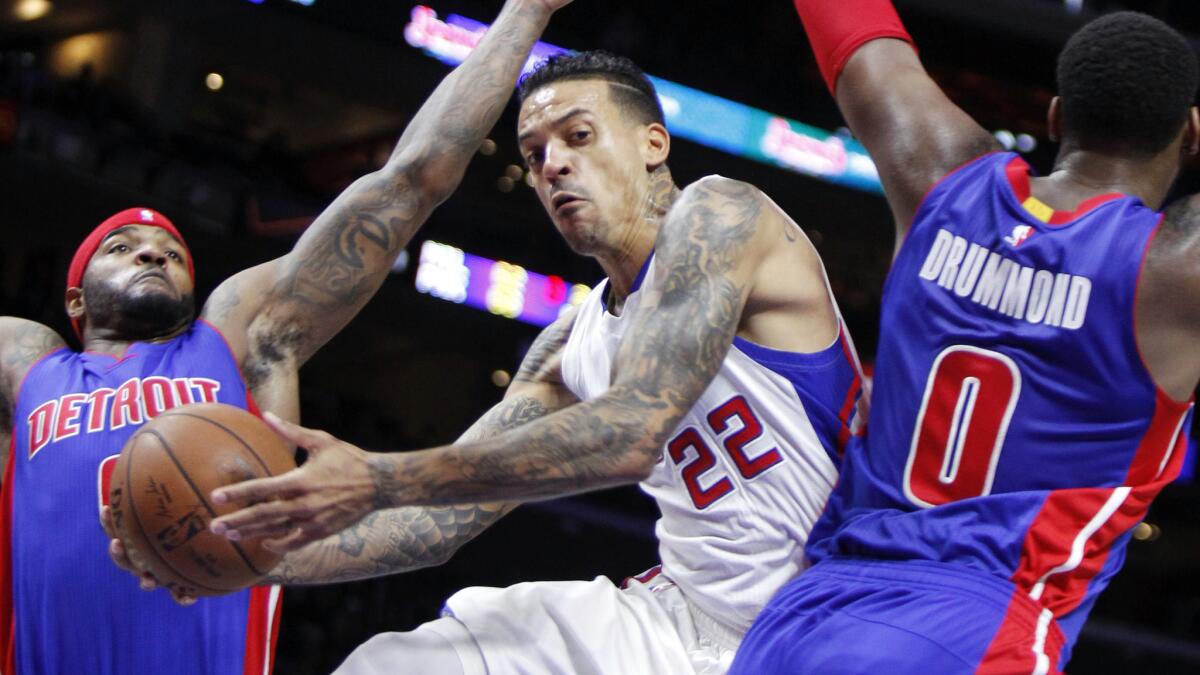 Clippers forward Matt Barnes, center, puts up a shot between Detroit Pistons forward Josh Smith, left, and center Andre Drummond during the first half of the Clippers' 113-91 win Monday.