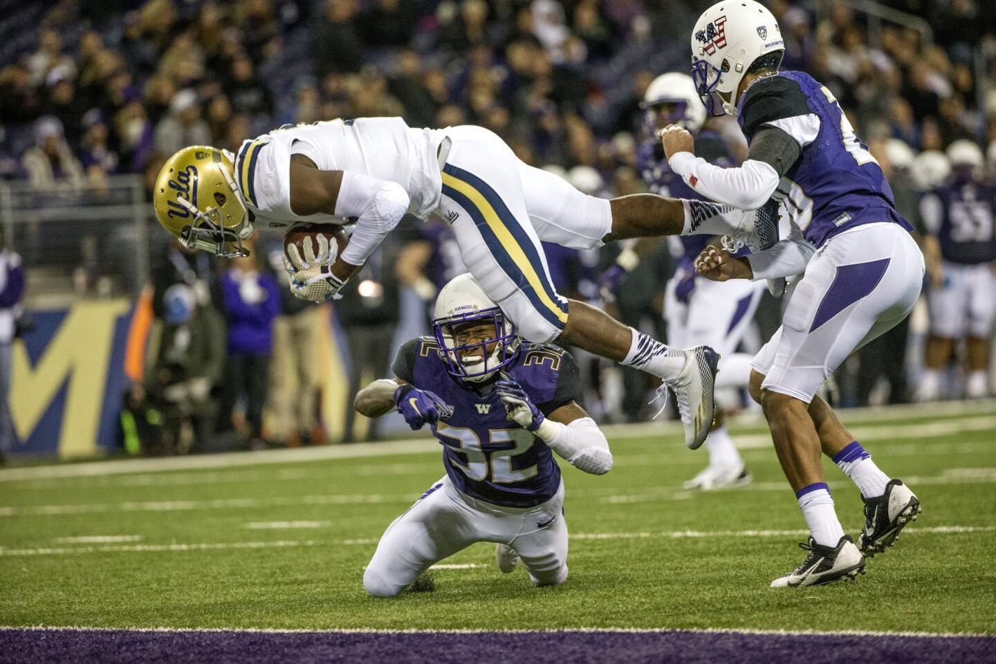 UCLA receiver Mossi Johnson flips into the end zone on a 15-yard pass play against Washington in the second half.