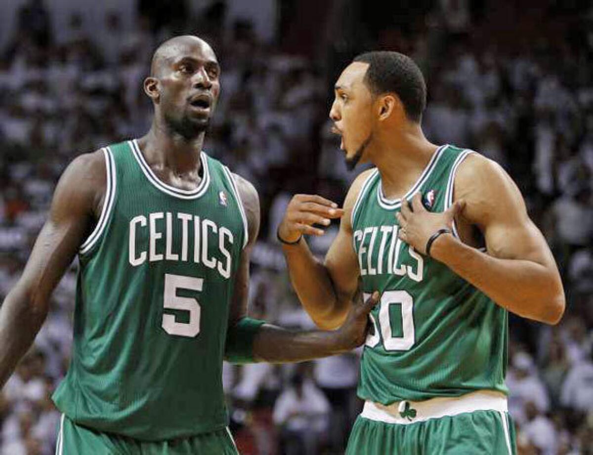 Kevin Garnett, left, and Ryan Hollins with the Celtics last season.