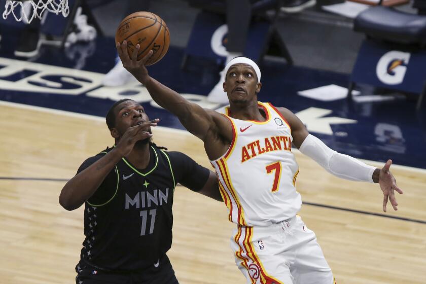 Atlanta Hawks' Rajon Rondo (7) goes up to the basket against Minnesota Timberwolves' Naz Reid (11) during the first half of an NBA basketball game Friday, Jan. 22, 2021, in Minneapolis. (AP Photo/Stacy Bengs)