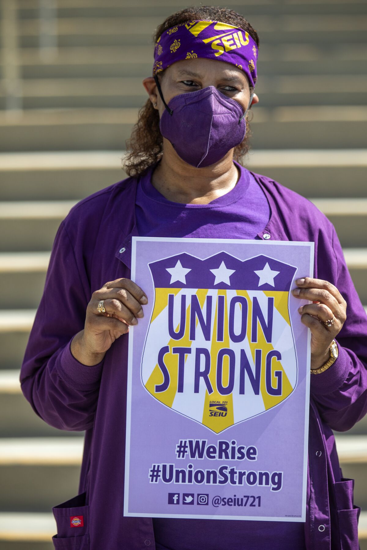 A person holds a "Union Strong" card.