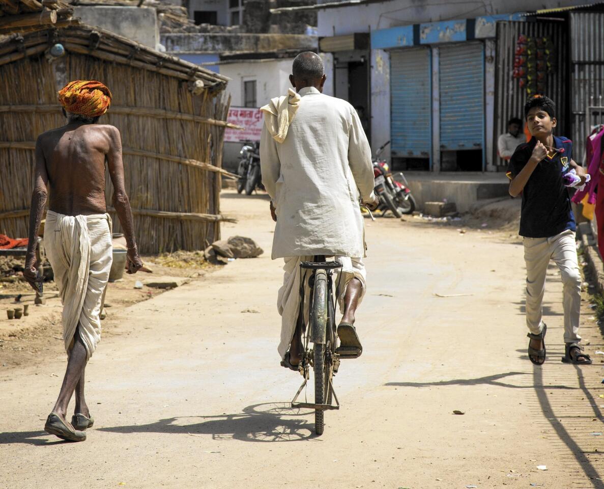 An Indian man getting around on a bicycle in Abhaneri.