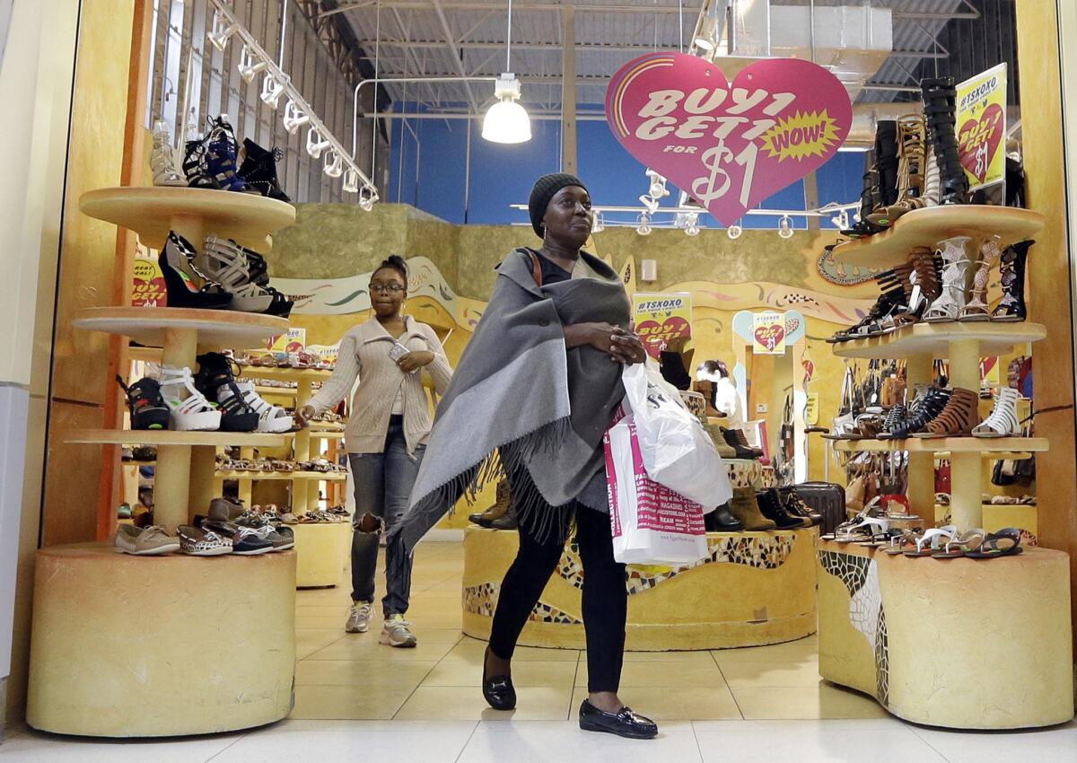 Customers shop at a shoe store in Miami on Feb. 9.