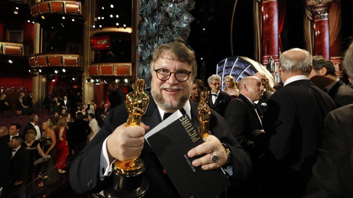 Guillermo del Toro holds the two Oscars he won for "The Shape of Water" at the Academy Awards on March 4 at the Dolby Theatre in Hollywood.
