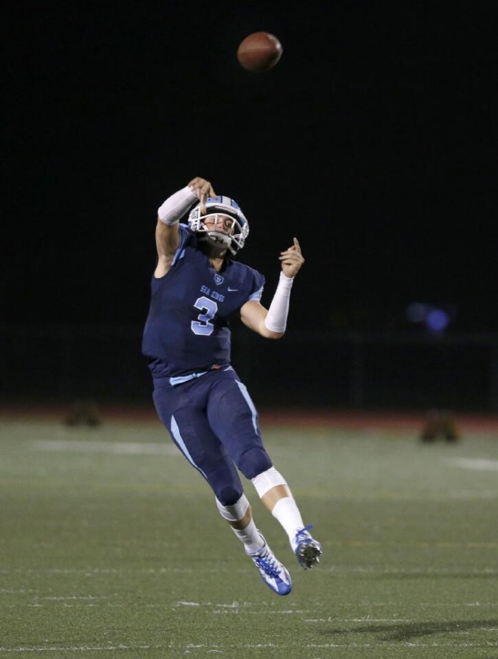 Corona del Mar quarterback Chase Garbers throws a long pass for a touchdown against Trabuco Hills on Friday.