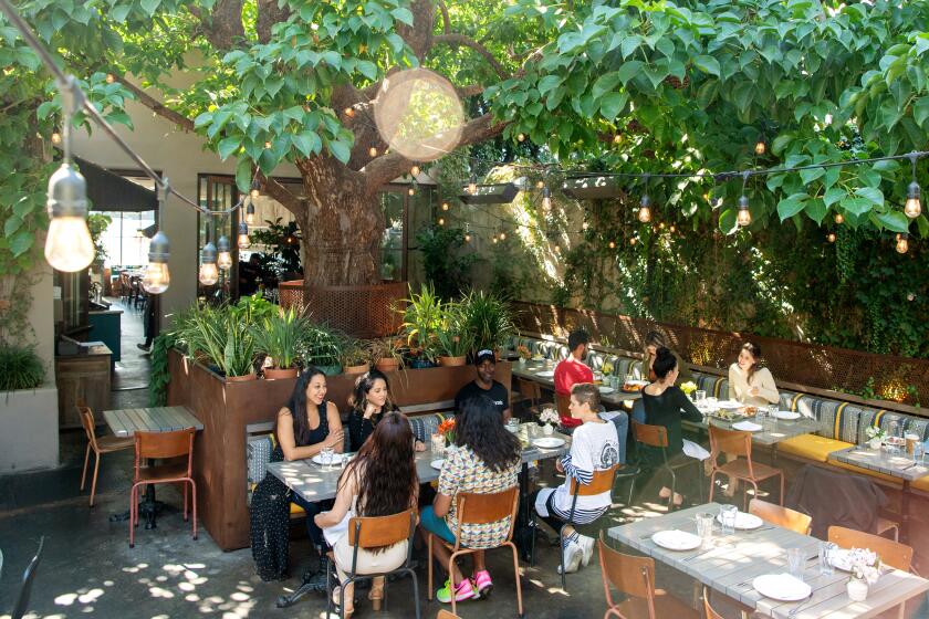 LOS ANGELES, CA- October 8, 2019: Special guests of the restaurant are invited to enjoy the patio and eat food during a photo shoot at Nic's On Beverly on Tuesday, October 8, 2019. (Mariah Tauger / Los Angeles Times)