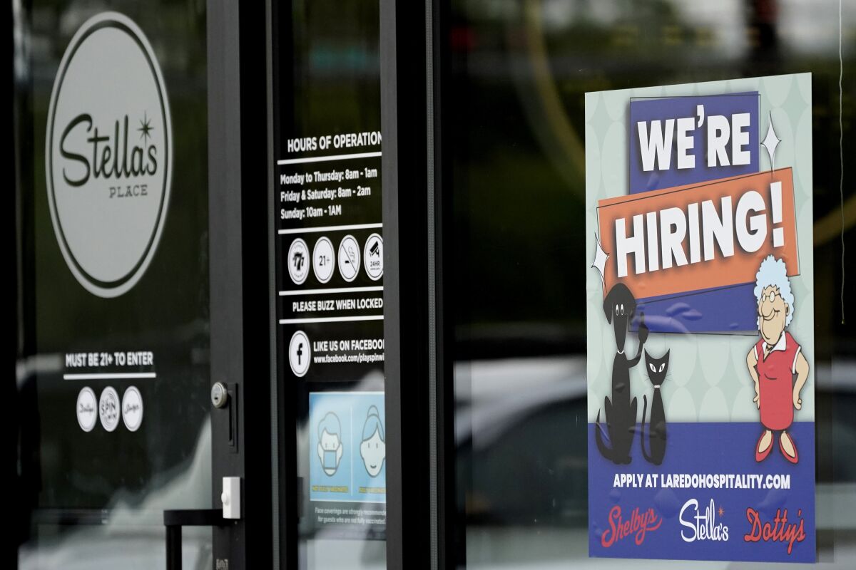 A hiring sign is seen at a Stella's Place cafe in Des Plaines, Ill., Sunday, July 11, 2021. Americans have started millions of new businesses in the last 18 months. As those businesses grow, many owners will consider hiring their first employees. (AP Photo/Nam Y. Huh)