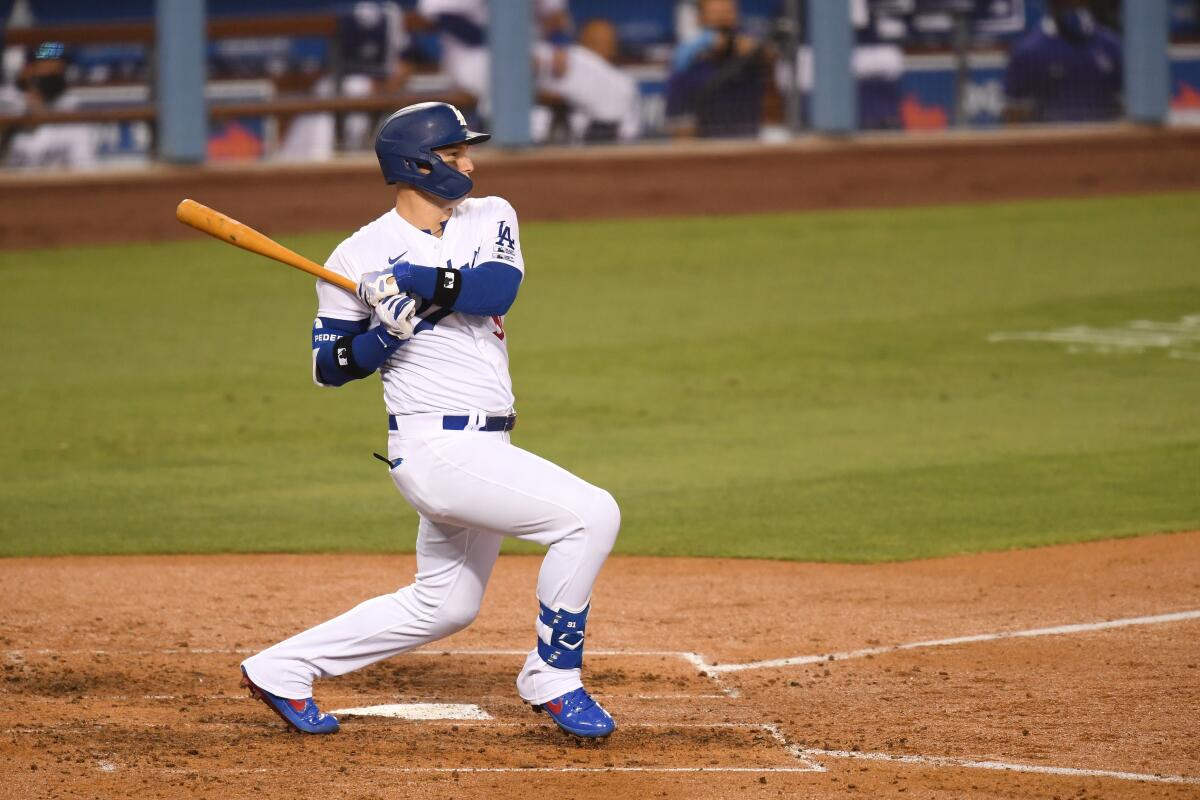 Joc Pederson singles in the fourth inning for the Dodgers against the Giants.