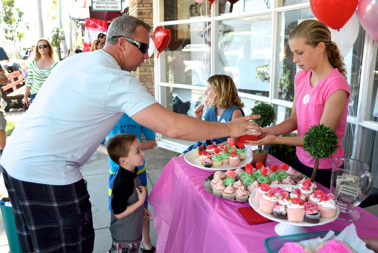 The Bell family supports the cause by purchasing cupcakes during the Courageous Cupcakes fundraiser Saturday at Classic Kids on Balboa Island.