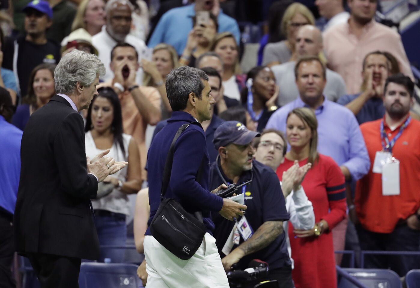 Chair umpire Carlos Ramos, right, is lead off the court by referee Brian Earley after Naomi Osaka, of Japan, defeated Serena Williams in the women's final of the U.S. Open tennis tournament, Saturday, Sept. 8, 2018, in New York. (AP Photo/Julio Cortez)