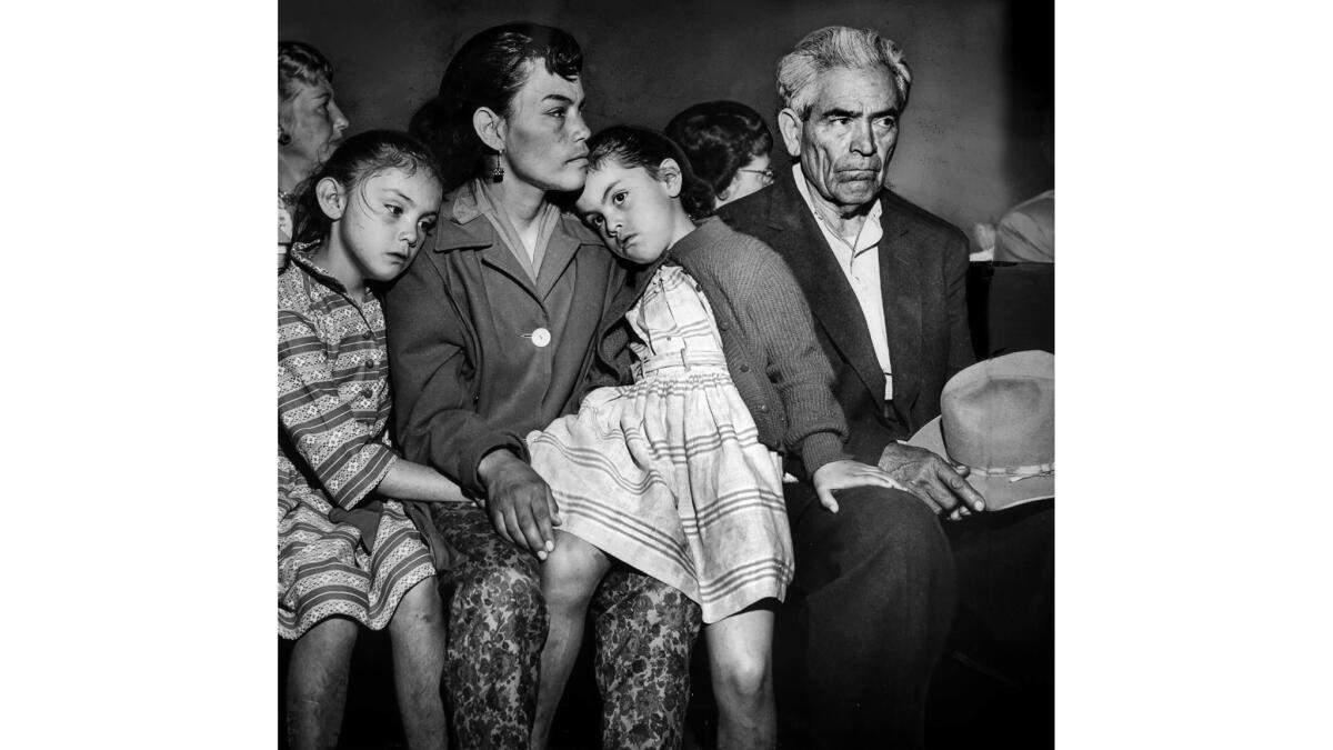 May 11, 1959: Victoria Angustian sits at council hearing with daughters Ida, 7, left, and Ivy, 5, and her father, Manuel Arechiga. Angustian was evicted from her home in Chavez Ravine with her three children. She told the City Council her family only wants to be treated fairly.