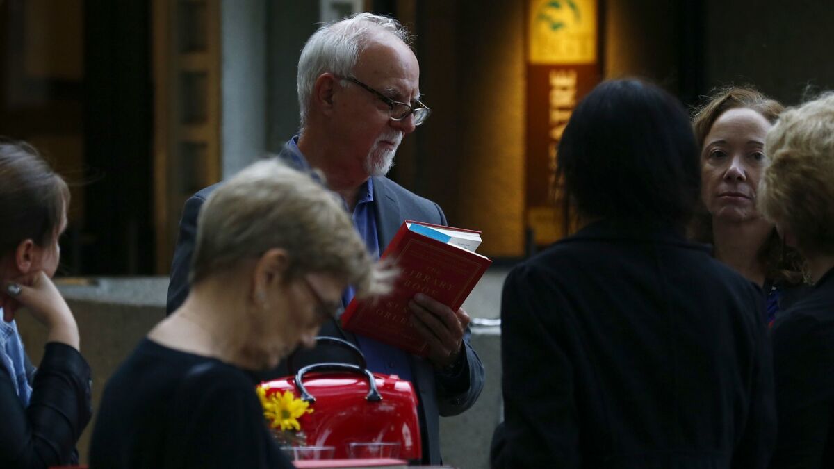 L.A. Times columnist Steve Lopez talks with guests during the book club gathering.