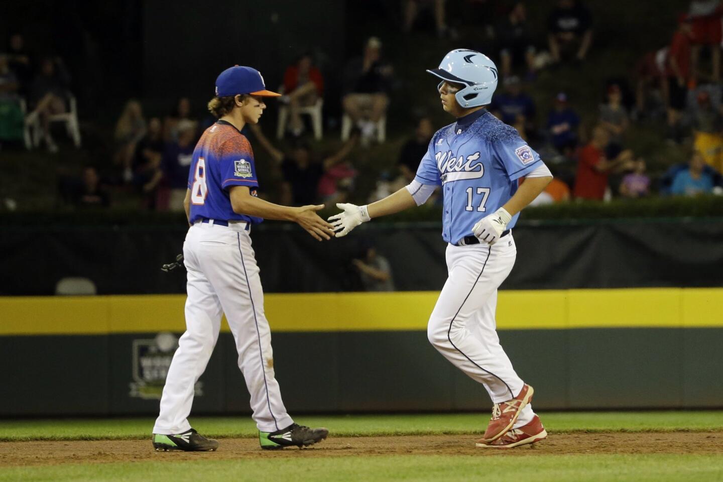 Levi Mendez, right, of Sweetwater Valley, greets Maddox Burr, of Bowling Green, Ky., as Mendez rounds the bases after hitting a two-run home run during the second inning.