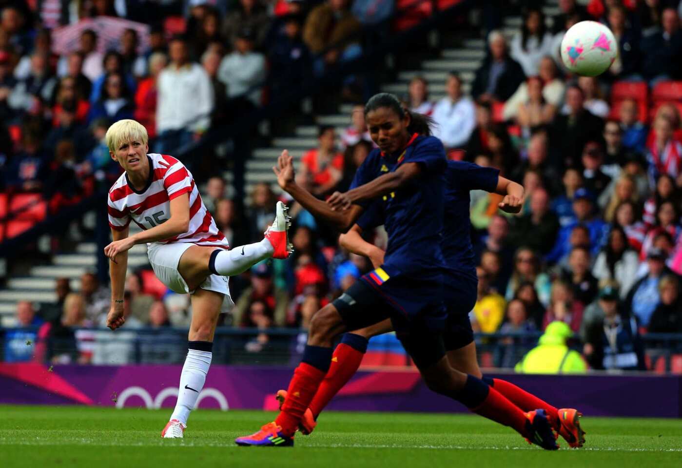 U.S. midfielder Megan Rapinoe, left, scores the opening goal against Colombia during the women's soccer first round Group G match of the London 2012 Olympics at Hampden Park.