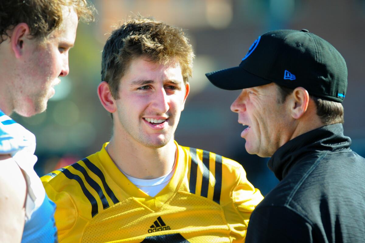 UCLA Coach Jim Mora talks with quarterback Josh Rosen, center, and offensive lineman Conor McDermott on Tuesday, the opening day of UCLA spring football practice.