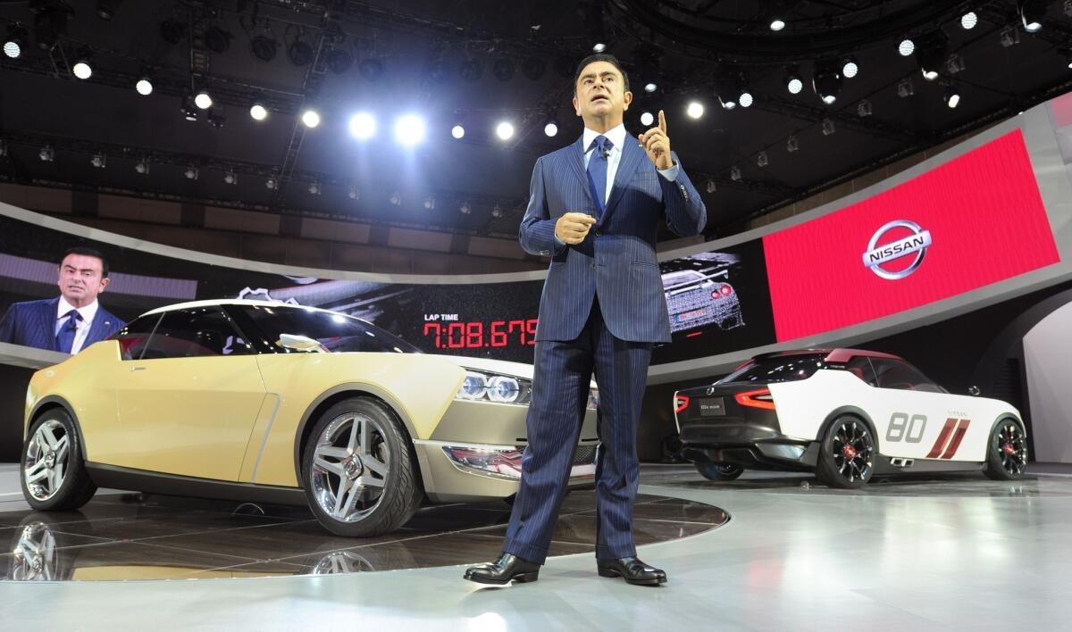 Nissan President Carlos Ghosn delivers a speech in front of an IDx Freeflow and IDx Nismo at the company's booth at the Tokyo Motor Show in November.