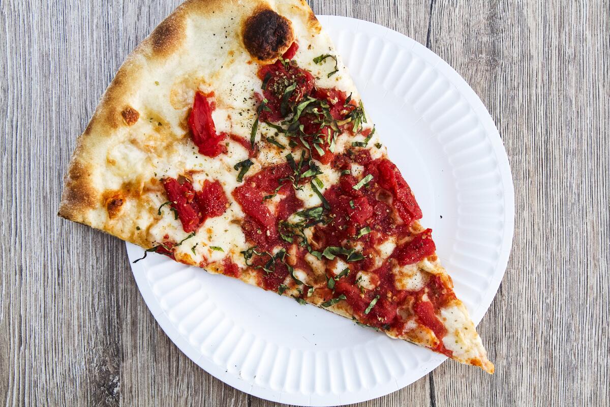 An overhead photo of a slice of New York-style Margherita pizza from Esco's.