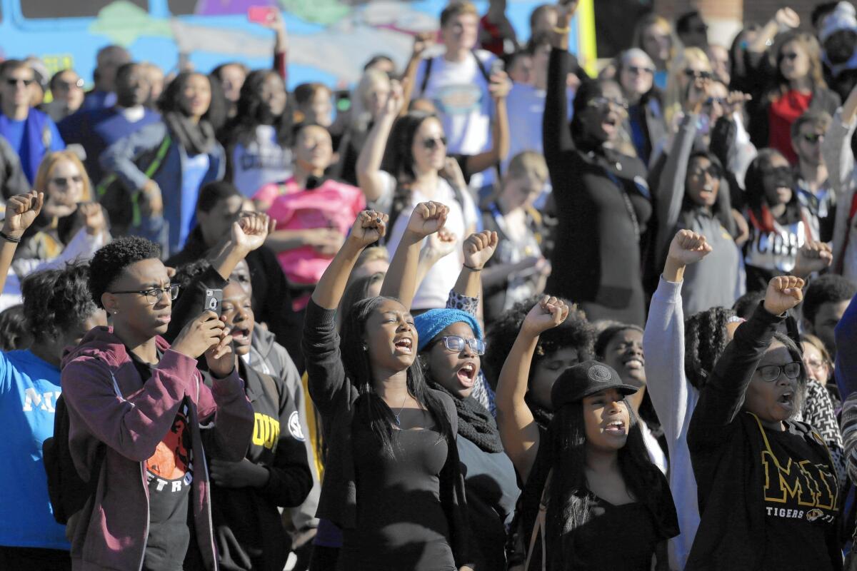 Students cheer while listening to members of the black student protest group Concerned Student 1950 speak Nov. 9, 2015, after the announcement University of Missouri President Tim Wolfe would resign at the school in Columbia, Mo. Wolfe resigned under pressure over concerns that he hadn’t properly addressed racism on campus.
