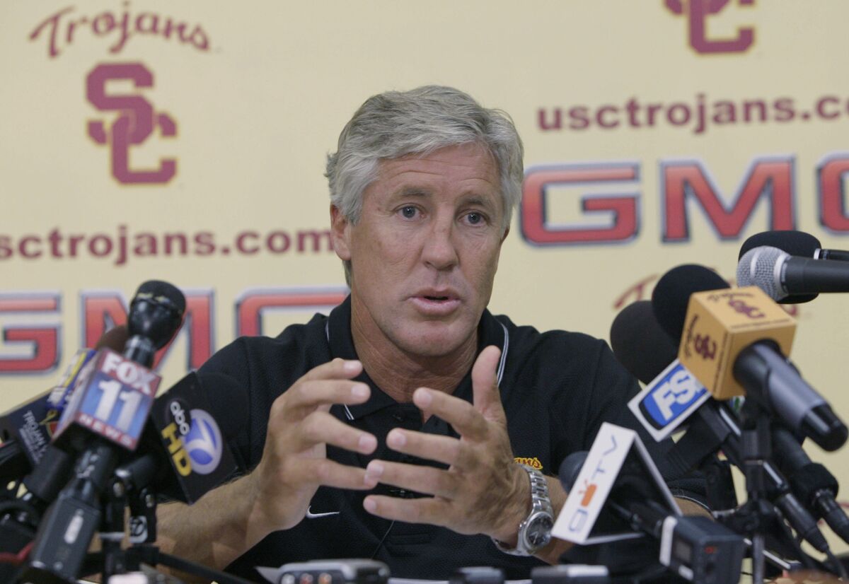 Then-USC football coach Pete Carroll speaks at a news conference 