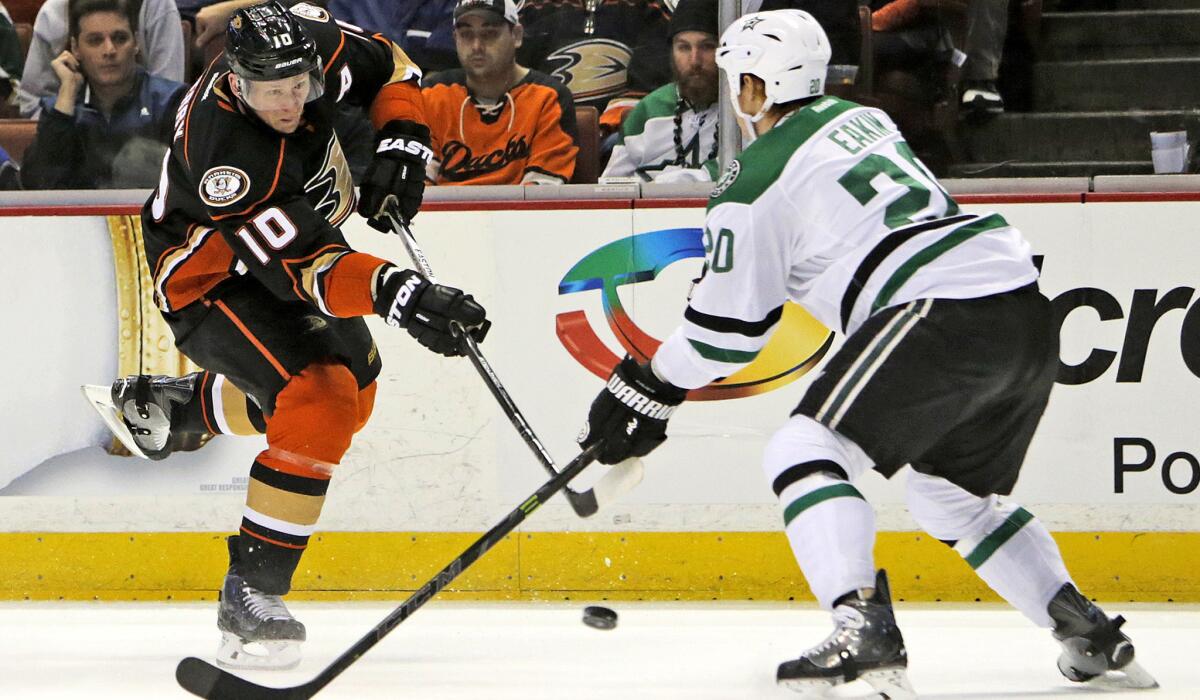 Ducks right wing Corey Perry looks to pass around Dallas Stars center Cody Eakin in the first period at Honda Center on April 8.