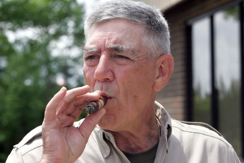 FILE - In this May 15, 2006, file photo, retired Marine Gunnery Sgt. R. Lee Ermey takes a break for a smoke outside New River Air Station's Staff NCO club in Jacksonville, N.C. Ermey, a former marine who made a career in Hollywood playing hard-nosed military men like Gunnery Sgt. Hartman in Stanley Kubrick's "Full Metal Jacket," has died. His longtime manager Bill Rogin says he died Sunday morning, April 15, 2018, from pneumonia-related complications. He was 74. (Randy Davey/The Jacksonville Daily News via AP, File)