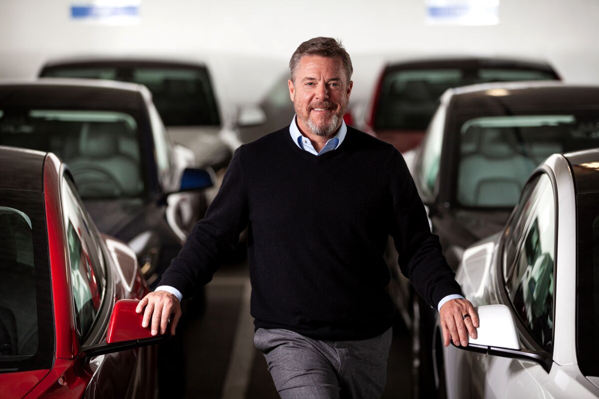 Autonomy Chief Executive Scott Painter stands with cars.